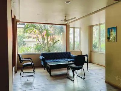 a living room with a couch and chairs in front of a window at 3 Bedroom River view apartment in Aluva, near Cochin Airport in Alwaye