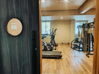 a gym with treadmills and exercise bikes in a room at 3 Bedroom River view apartment in Aluva, near Cochin Airport in Alwaye