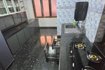 a kitchen with a black counter top and a sink at Entire 4 Bedroom Villa in Kannur in Edakkād
