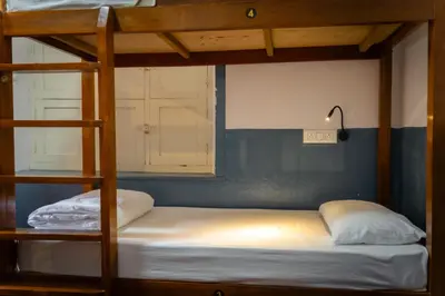 a bedroom with a bunk bed with a ladder at Leo Vishroam in Mysore