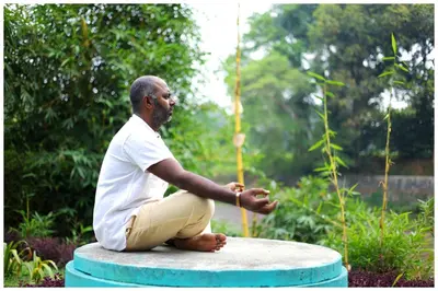 a man sitting on top of a fountain at Vajra Periyar Heritage in Alwaye