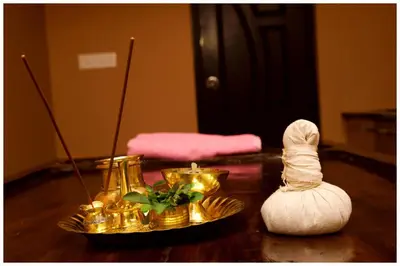 a table with gold items on top of a table at Vajra Periyar Heritage in Alwaye
