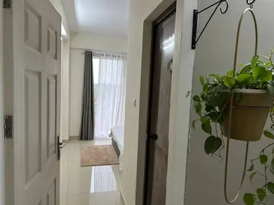 a hallway with a door with a potted plant on it at Memmsta Blooming Bird Guruvayur in Guruvāyūr