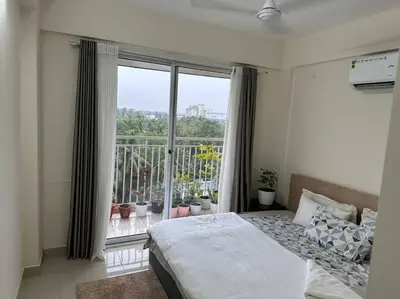 a bedroom with a bed and a large window at Memmsta Blooming Bird Guruvayur in Guruvāyūr