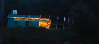 a building with christmas lights on it at night at Aamis Home Stay in Vattavada