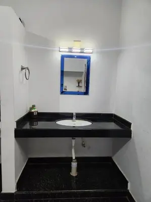 a bathroom with a sink and a mirror at NJM Villa in Coimbatore