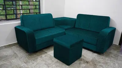 a green couch and a chair in a room at Prakruthi Home stay in Kanjikode