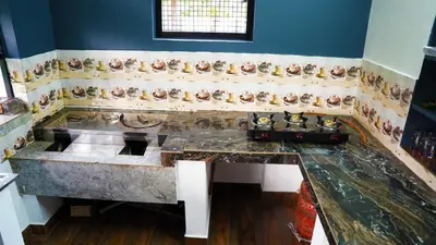a kitchen with a sink and a counter top at Prakruthi Home stay in Kanjikode