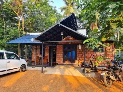 a small house with a car parked in front of it at Prakruthi Home stay in Kanjikode