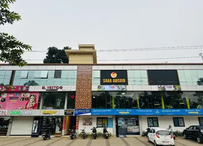 a building with motorcycles parked in front of it at Sara Archid in Kommeri