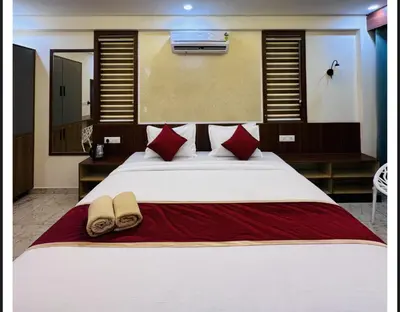 a bedroom with a large white bed with red pillows at Sara Archid in Kommeri