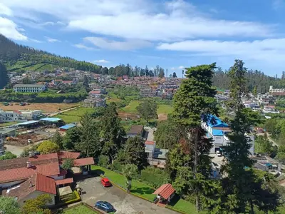 an aerial view of a small village in a valley at HRS Budget Rooms in Ooty