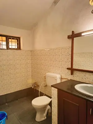 a bathroom with a toilet and a sink at Boughn Villa in Kozhikode