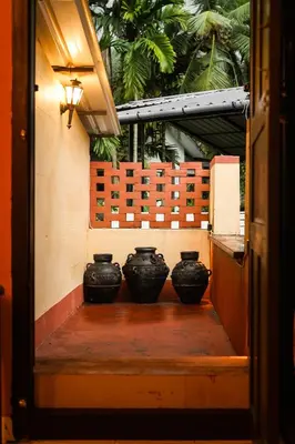 a group of black vases sitting on a step at Boughn Villa in Kozhikode