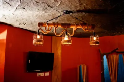 a group of lights hanging from a ceiling at Beehive staycations in Ambalavayal