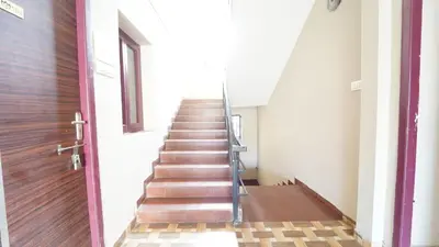a staircase in a building with a wooden door at Hotel Varun 1 bhk in Coimbatore