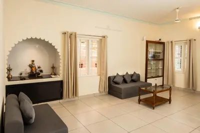 a living room with a couch and a table at Chitralayam Home stay in Guruvāyūr