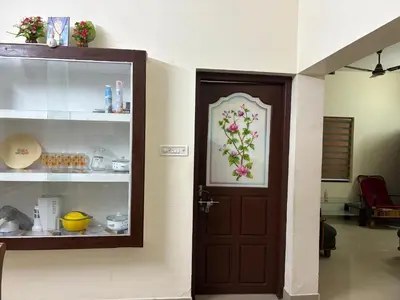 a door with a picture of flowers on the wall at Moms Villa in Nedumbassery