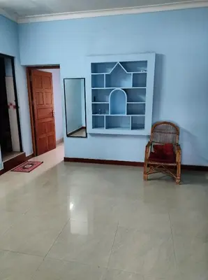 a room with a chair and a painting on the wall at Beautiful and Peaceful house in Kanjikode