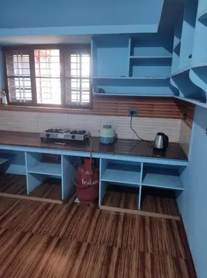 a kitchen with a blue counter top in a room at Beautiful and Peaceful house in Kanjikode