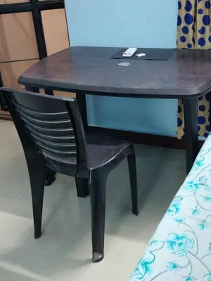 a black desk with a chair and a laptop on it at Beautiful and Peaceful house in Kanjikode