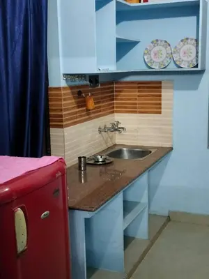 a kitchen counter with a sink in a room at Beautiful and Peaceful house in Kanjikode