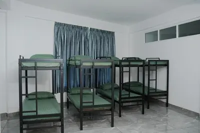 a group of bunk beds in a room at Hotel Aamis Villa in Pulpally