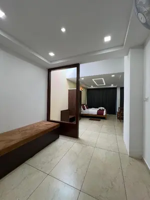 a large room with a bed and a mirror at Hotel Aamis Villa in Pulpally