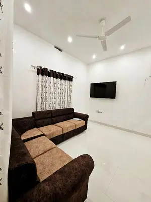 a living room with a couch and a flat screen tv at Mariya Home Stay in Kanjikode