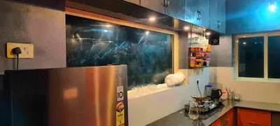 a kitchen with a stainless steel refrigerator and a window at Homestay Rooms Muzhakkunnu Near Kannur International Airport in Iritti