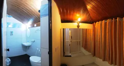 a bathroom with a toilet and a sink at Homestay Rooms Muzhakkunnu Near Kannur International Airport in Iritti