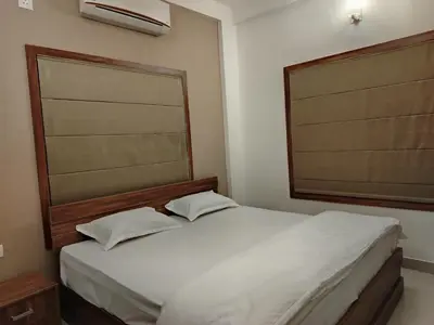 a bedroom with a white bed and a window at Wild Wind Resort in Batheri