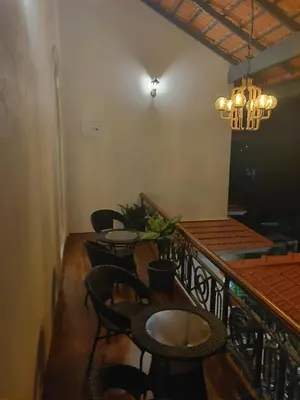 a dining room with tables and chairs and a chandelier at The Elegant homes in Kushālnagar