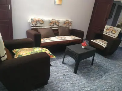 a living room with couches and a coffee table at Mithu's Nest-Ur Holiday Abode in Coimbatore