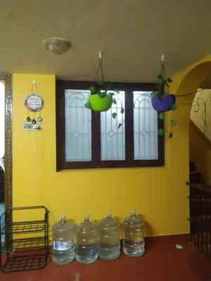 a room with a yellow wall withousandousandousandousandousandousandousandousandousand at Mithu's Nest-Ur Holiday Abode in Coimbatore