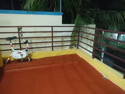 a scooter parked on the side of a balcony at Mithu's Nest-Ur Holiday Abode in Coimbatore