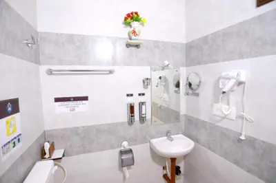 a bathroom with a sink and a toilet at Base9 Family Lounge -Cochin Airport in Nedumbassery