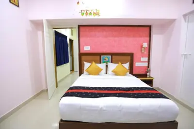 a bedroom with a large white bed with yellow pillows at Base9 Family Lounge -Cochin Airport in Nedumbassery