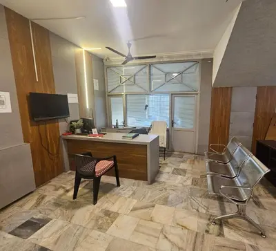 an office with a desk and chairs in a room at Regent Tourist Home in Palakkad