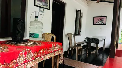 a table with a bottle of water on top of it at Tharavadu Homestay in Athirappilly
