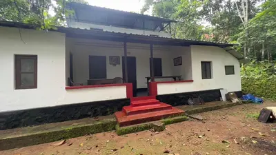 a house with red steps in front of it at Tharavadu Homestay in Athirappilly