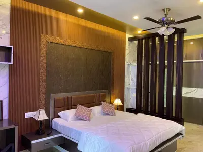 a bedroom with a bed with a ceiling fan at Kings Villa Mysore in Mysore