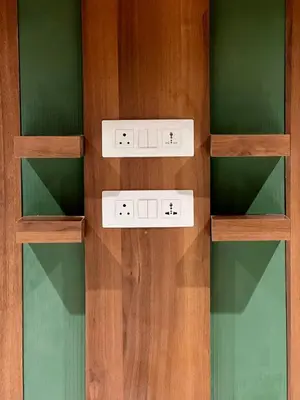 two shelves in a room with green and wooden at City Palace Hotel in Ooty