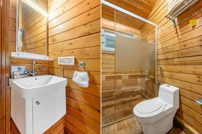 a bathroom with wooden walls and a toilet and a sink at StayVista at The Woodscapes with Lawn & Views in Ooty