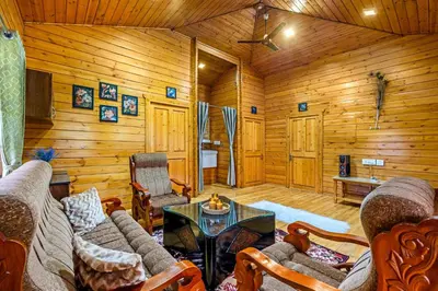 a living room with a couch and a table at StayVista at The Woodscapes with Lawn & Views in Ooty