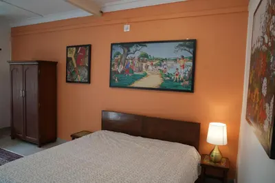 a bedroom with a bed and a painting on the wall at Perfect getaway in Mysore