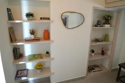 a room with white shelves and a mirror at Perfect getaway in Mysore