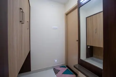 a bathroom with a mirror and a walk in closet at Hotel PRM Aruna Archadia in Erode