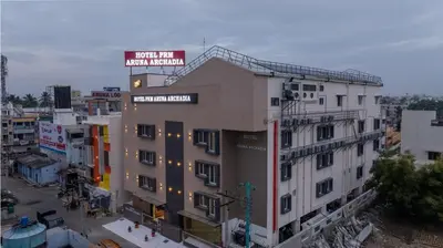 a building with a sign on the top of it at Hotel PRM Aruna Archadia in Erode