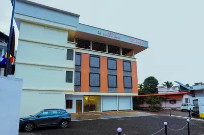 a car parked in front of a building at Hotel Diamond Castle in Manjeri